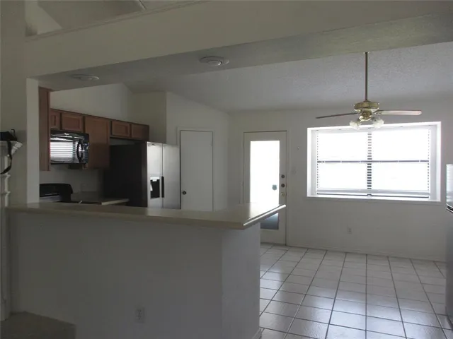 a view of empty room with window and fireplace