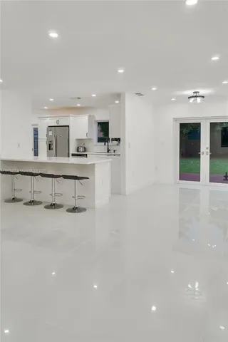 a large white kitchen with a large window