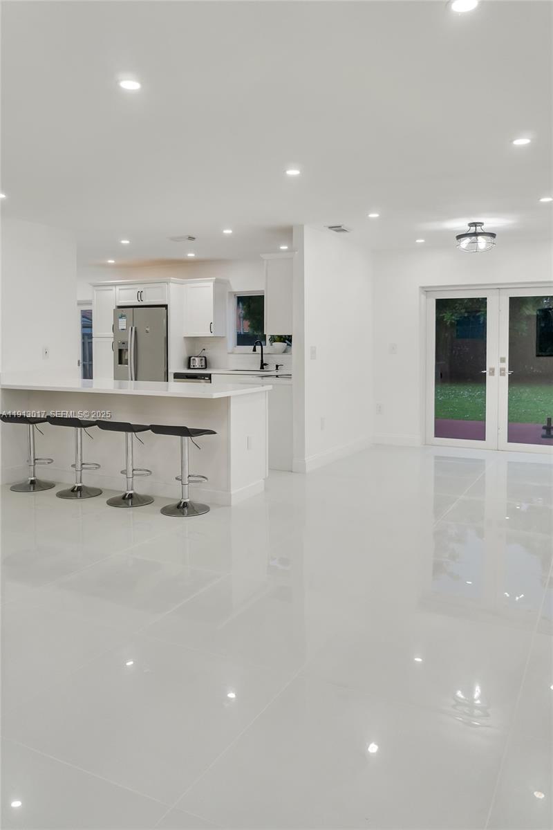 15309 Southwest 183rd Terrace Miami, FL 33187 - Photo 1 of 30 a large white kitchen with a large window
