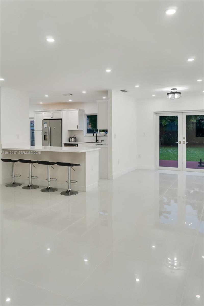 15309 Southwest 183rd Terrace Miami, FL 33187 - Photo 13 of 30 a view of a kitchen with kitchen island a sink stainless steel appliances and cabinets