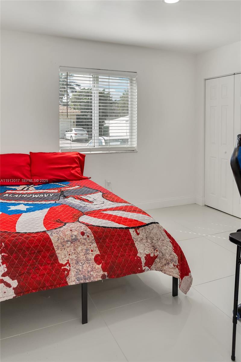 15309 Southwest 183rd Terrace Miami, FL 33187 - Photo 15 of 30 a bedroom with a bed and window