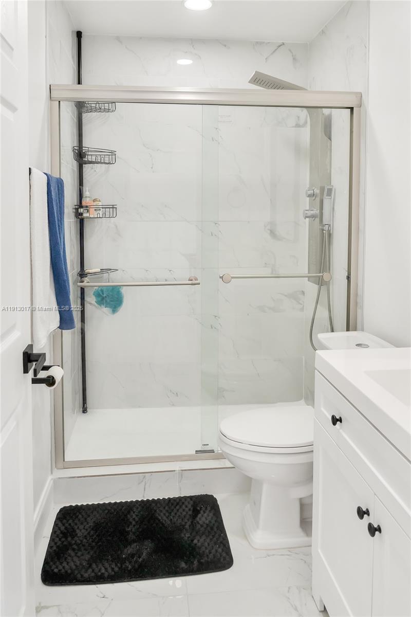 15309 Southwest 183rd Terrace Miami, FL 33187 - Photo 16 of 30 a bathroom with a toilet a sink and a shower