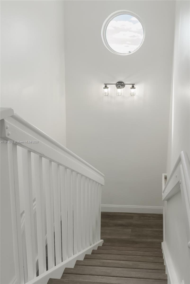 15309 Southwest 183rd Terrace Miami, FL 33187 - Photo 18 of 30 a view of a room with wooden floor and white walls