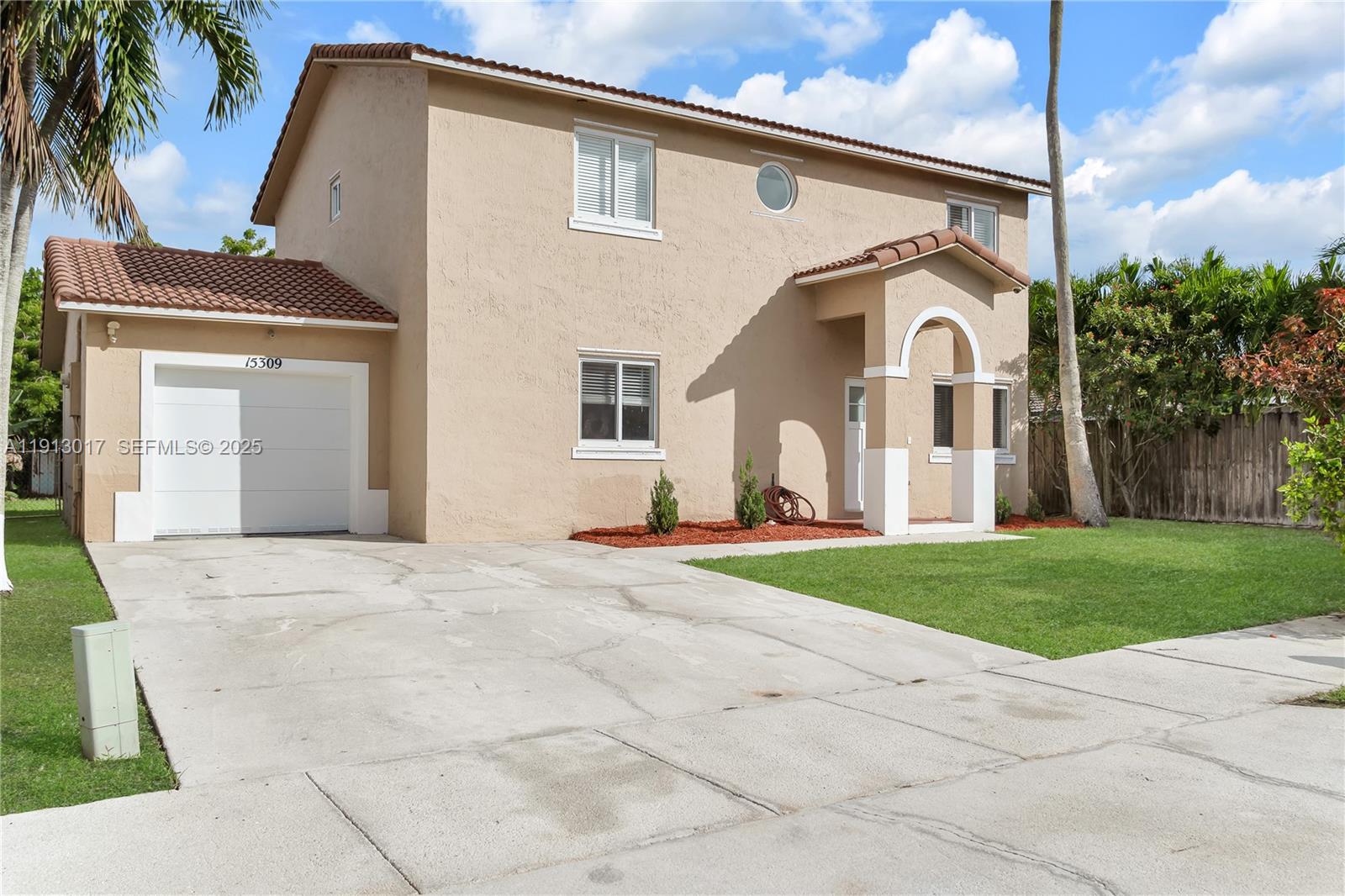 15309 Southwest 183rd Terrace Miami, FL 33187 - Photo 2 of 30 a front view of a house with a yard and garage