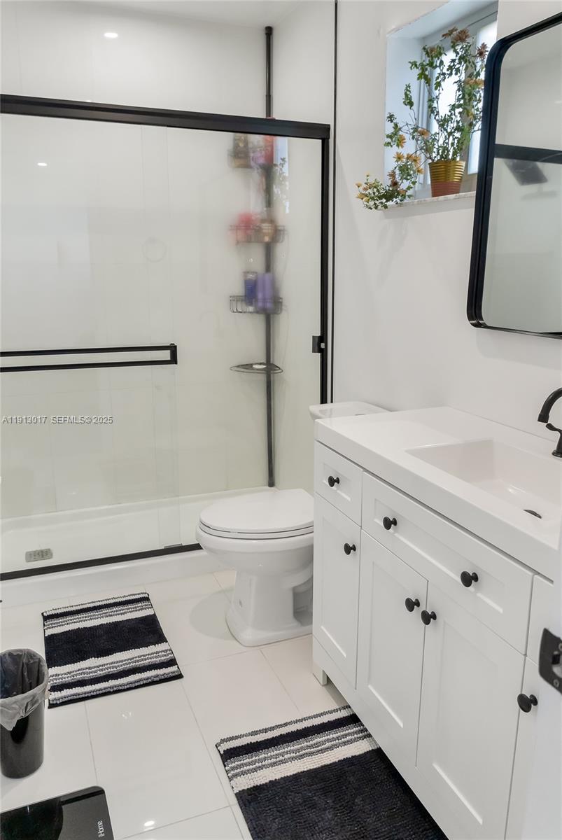 15309 Southwest 183rd Terrace Miami, FL 33187 - Photo 22 of 30 a bathroom with a toilet a sink and a mirror