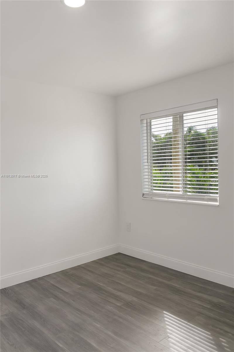 15309 Southwest 183rd Terrace Miami, FL 33187 - Photo 24 of 30 wooden floor in an empty room with a window