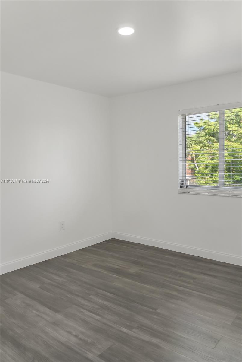 15309 Southwest 183rd Terrace Miami, FL 33187 - Photo 26 of 30 a view of an empty room with wooden floor and a window