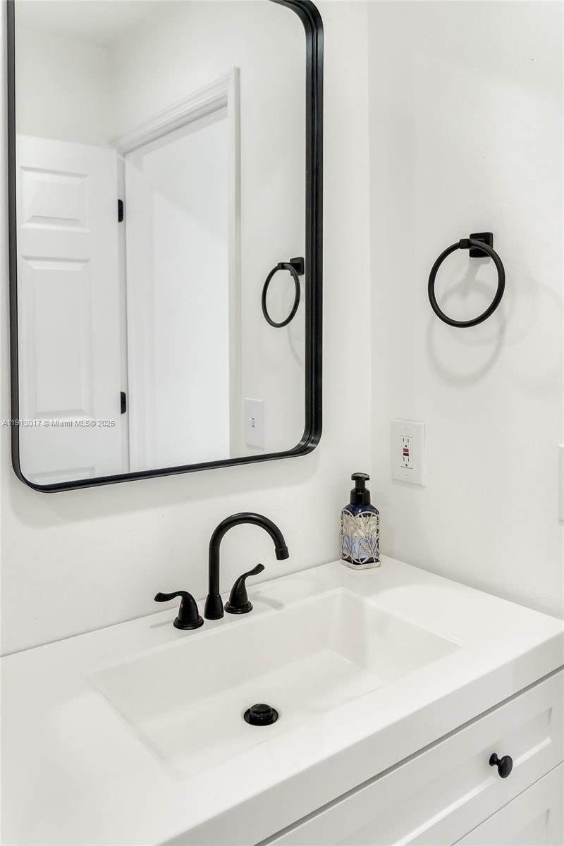15309 Southwest 183rd Terrace Miami, FL 33187 - Photo 30 of 30 a bathroom with a sink and a mirror