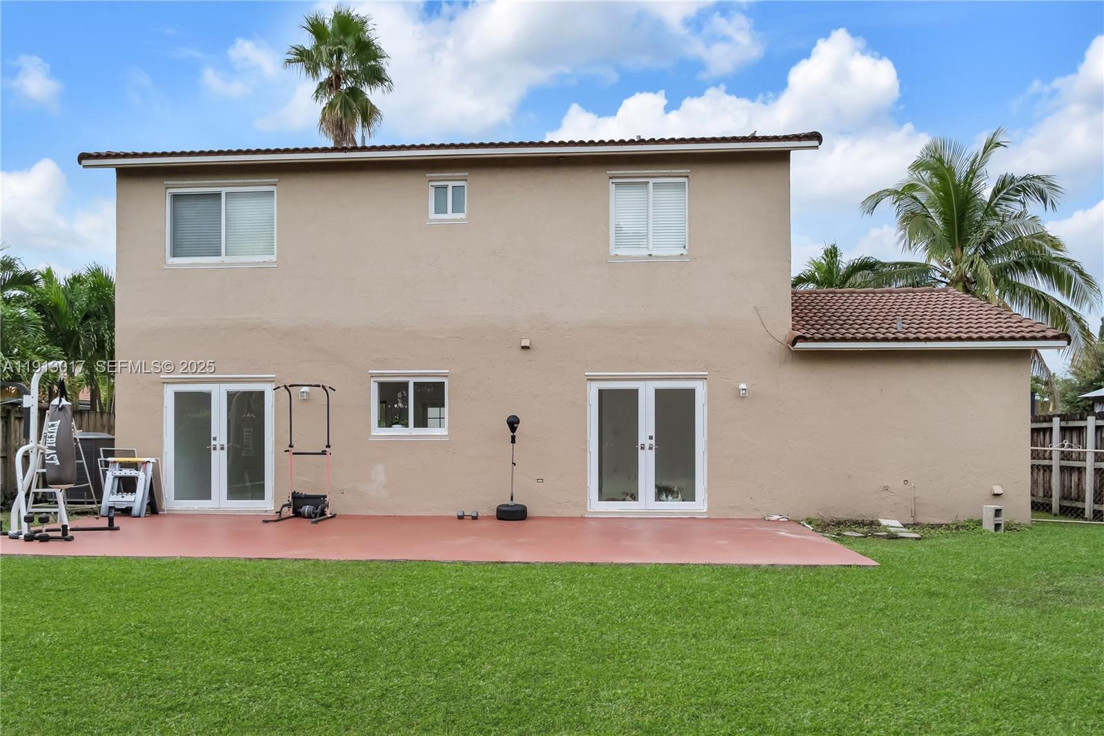 15309 Southwest 183rd Terrace Miami, FL 33187 - Photo 3 of 30 a front view of house with yard and outdoor seating