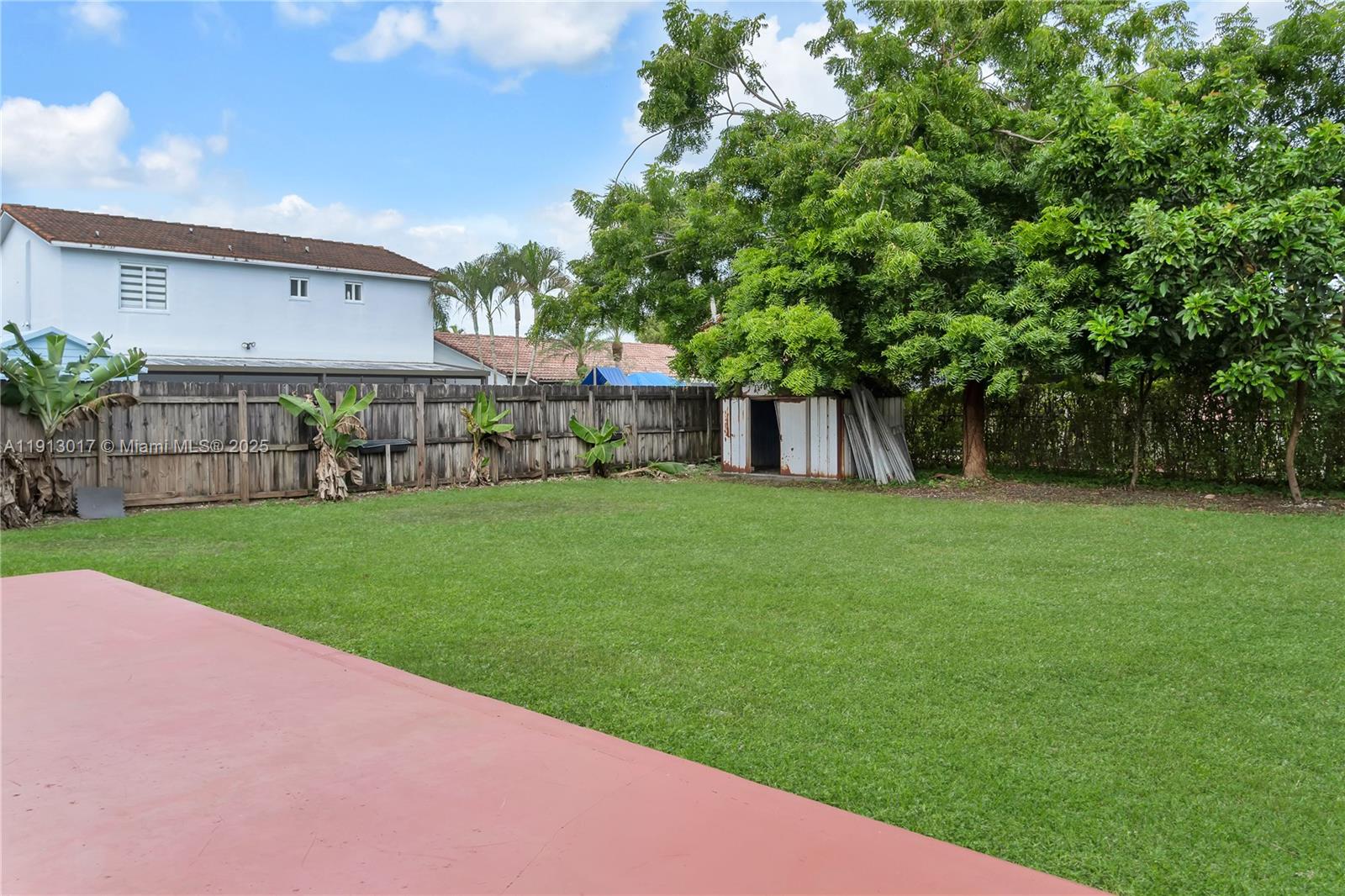 15309 Southwest 183rd Terrace Miami, FL 33187 - Photo 5 of 30 a view of a house with a yard and a large tree