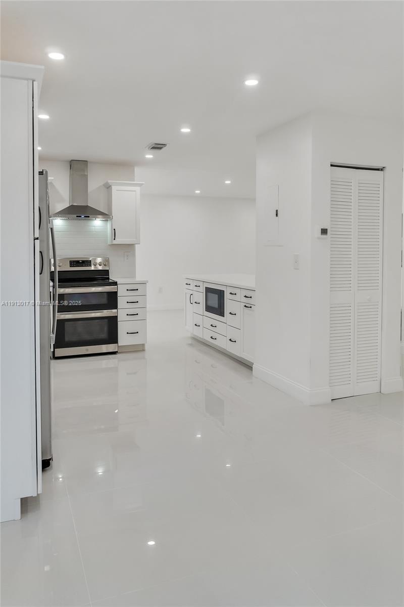 15309 Southwest 183rd Terrace Miami, FL 33187 - Photo 8 of 30 a kitchen with stainless steel appliances a refrigerator and stove