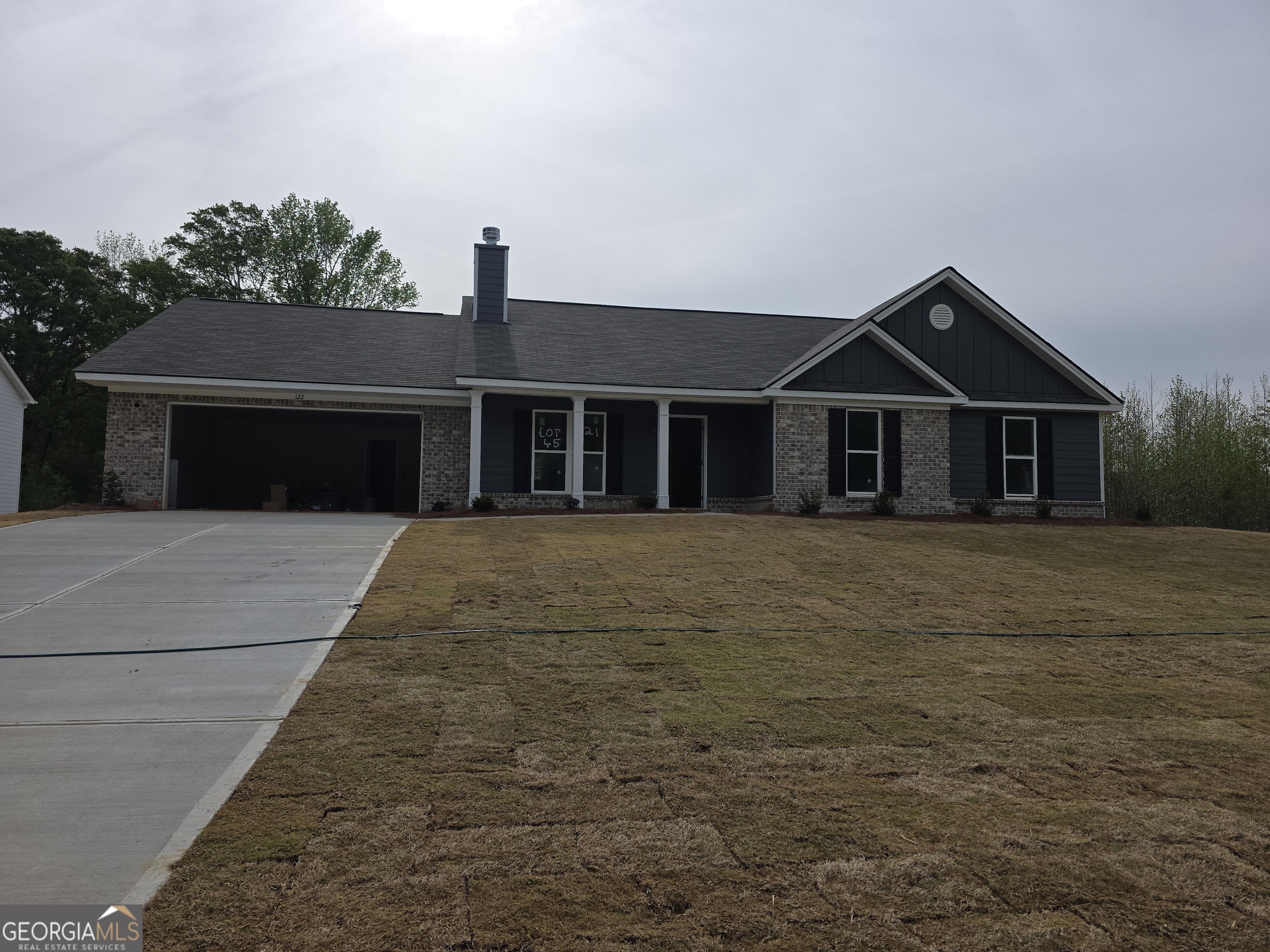 221 Windrow Trail, Unit 45 Statham, GA 30666 - Photo 3 of 3 a front view of a house with a garden