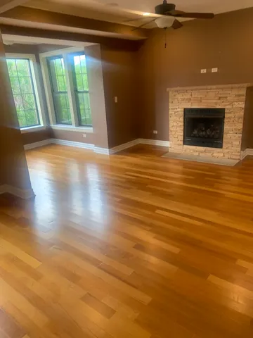 wooden floor in an empty room with a fireplace