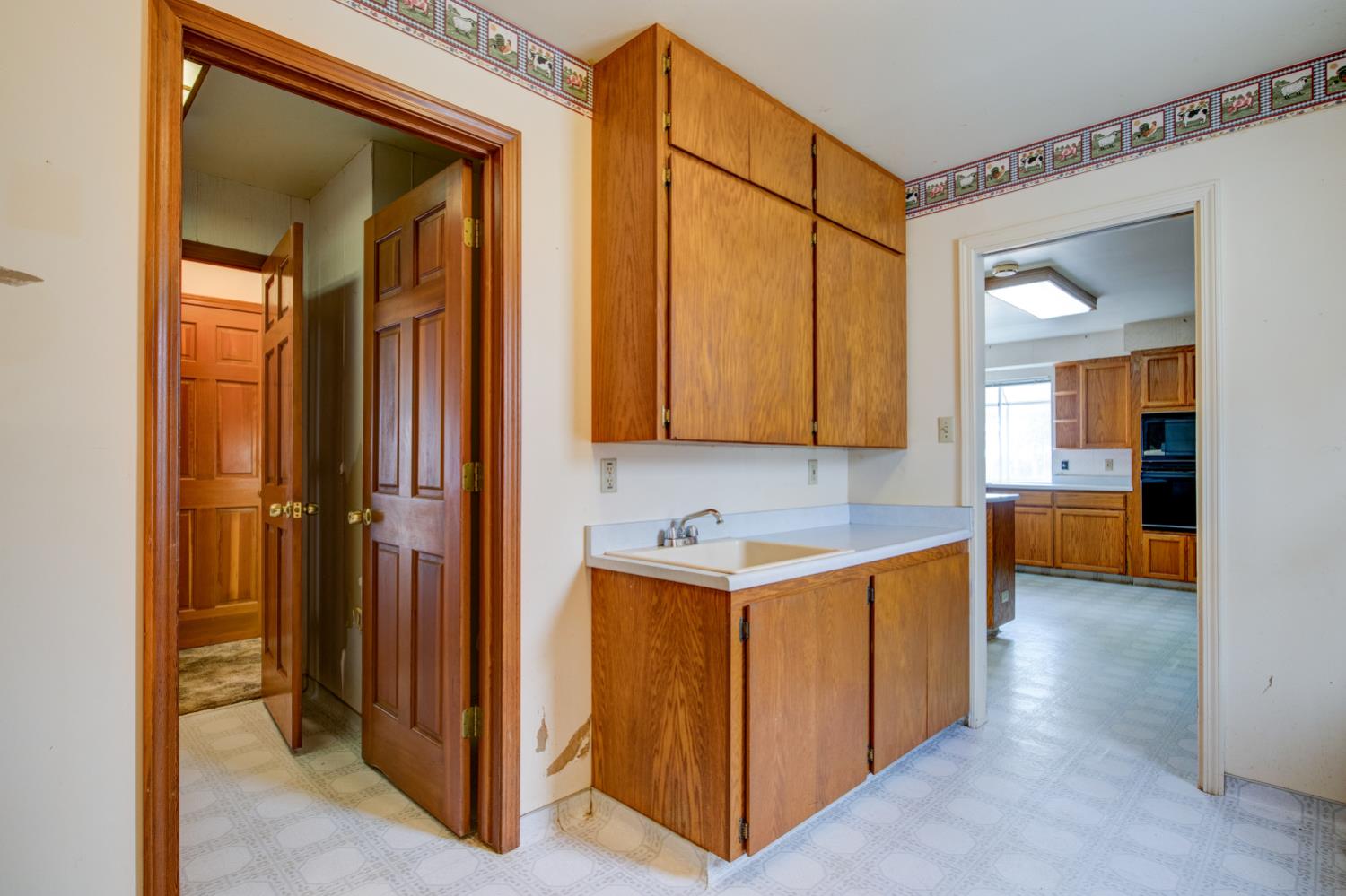 11120 Courier Road Plymouth, CA 95669 - Photo 17 of 73 a view of a hallway with wooden floor and a kitchen