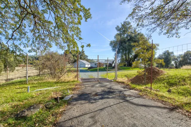 a house view with swimming pool in front of it