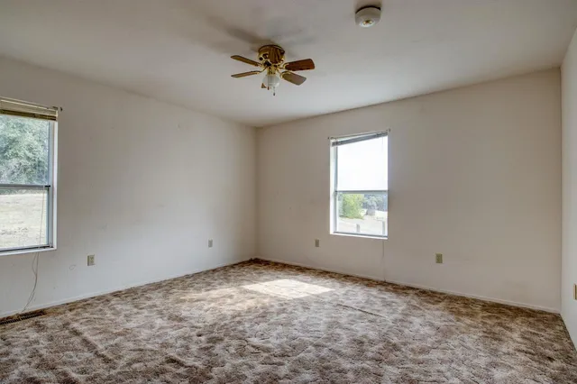 a view of a house with backyard and garden