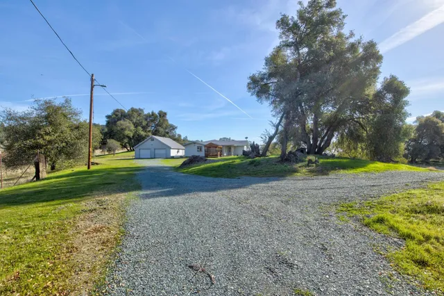 a view of a house with a yard and sitting area