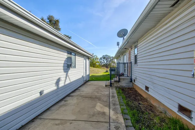 a backyard of a house with table and chairs