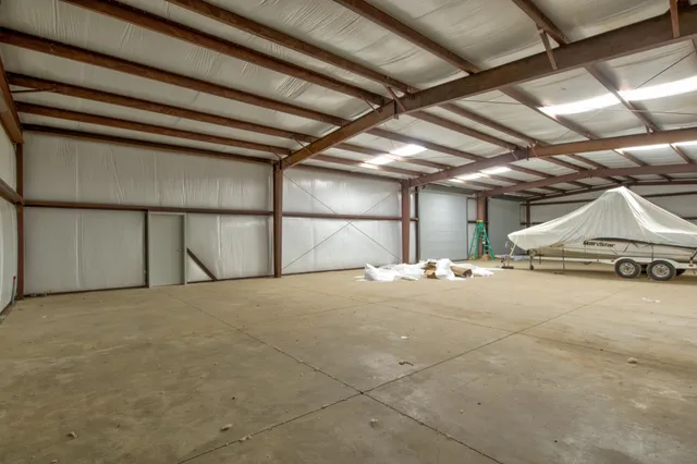 an aerial view of a house with a yard and mountain view in back