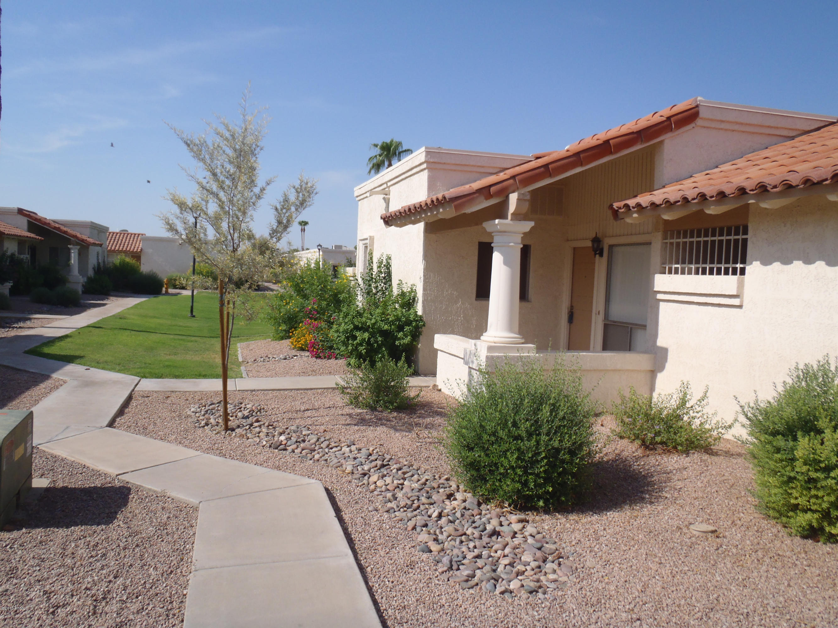 95 North Cooper Road, Unit 45 Chandler, AZ 85225 - Photo 1 of 26 a front view of a house with a yard