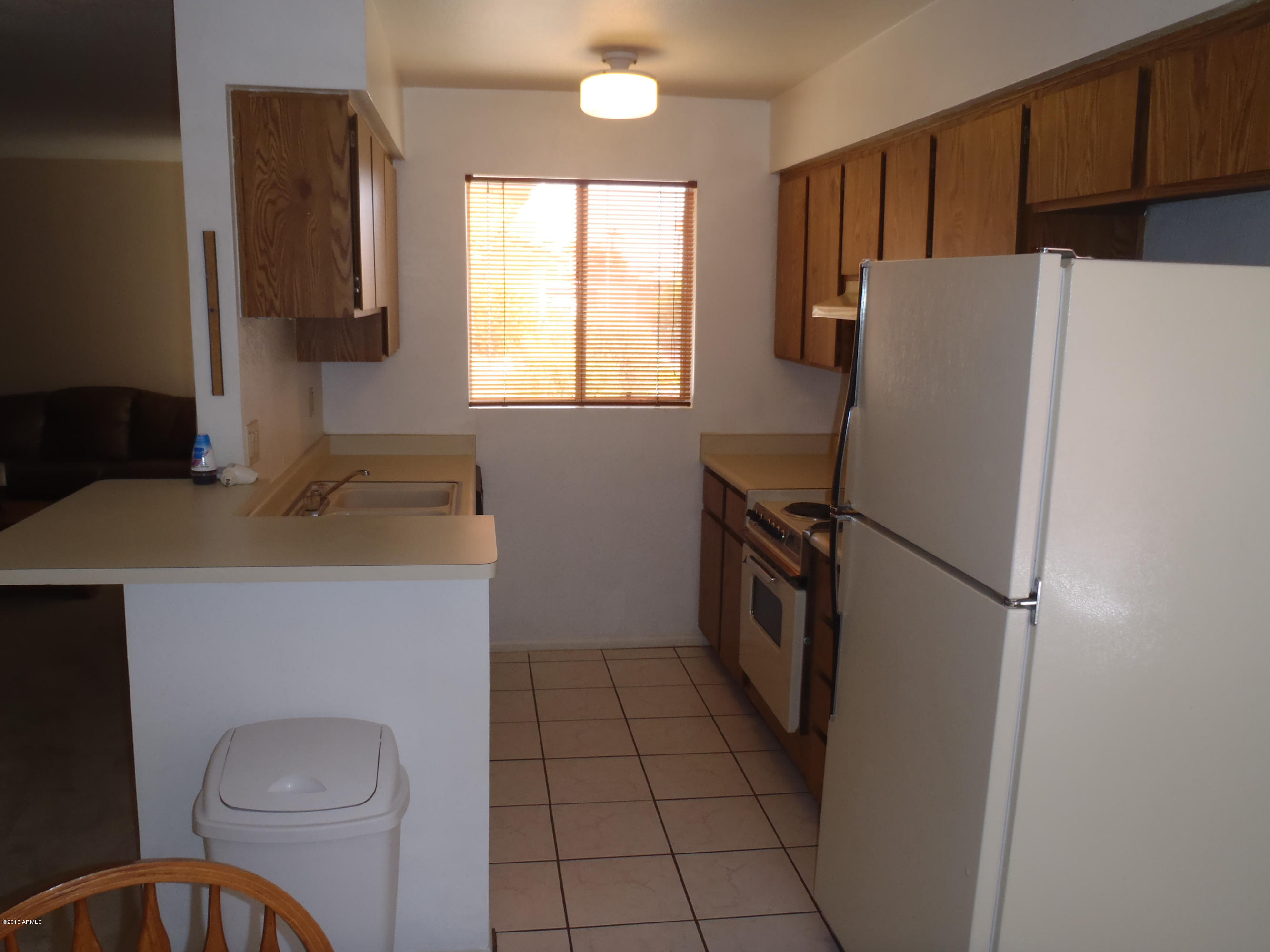 95 North Cooper Road, Unit 45 Chandler, AZ 85225 - Photo 2 of 26 a white refrigerator freezer and a stove sitting inside of a kitchen