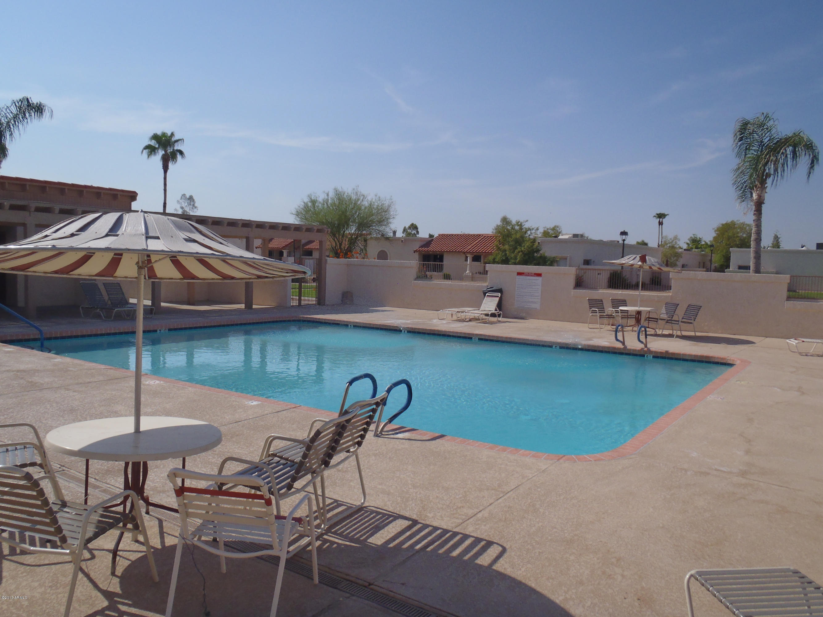 95 North Cooper Road, Unit 45 Chandler, AZ 85225 - Photo 26 of 26 a view of a backyard with a patio and swimming pool