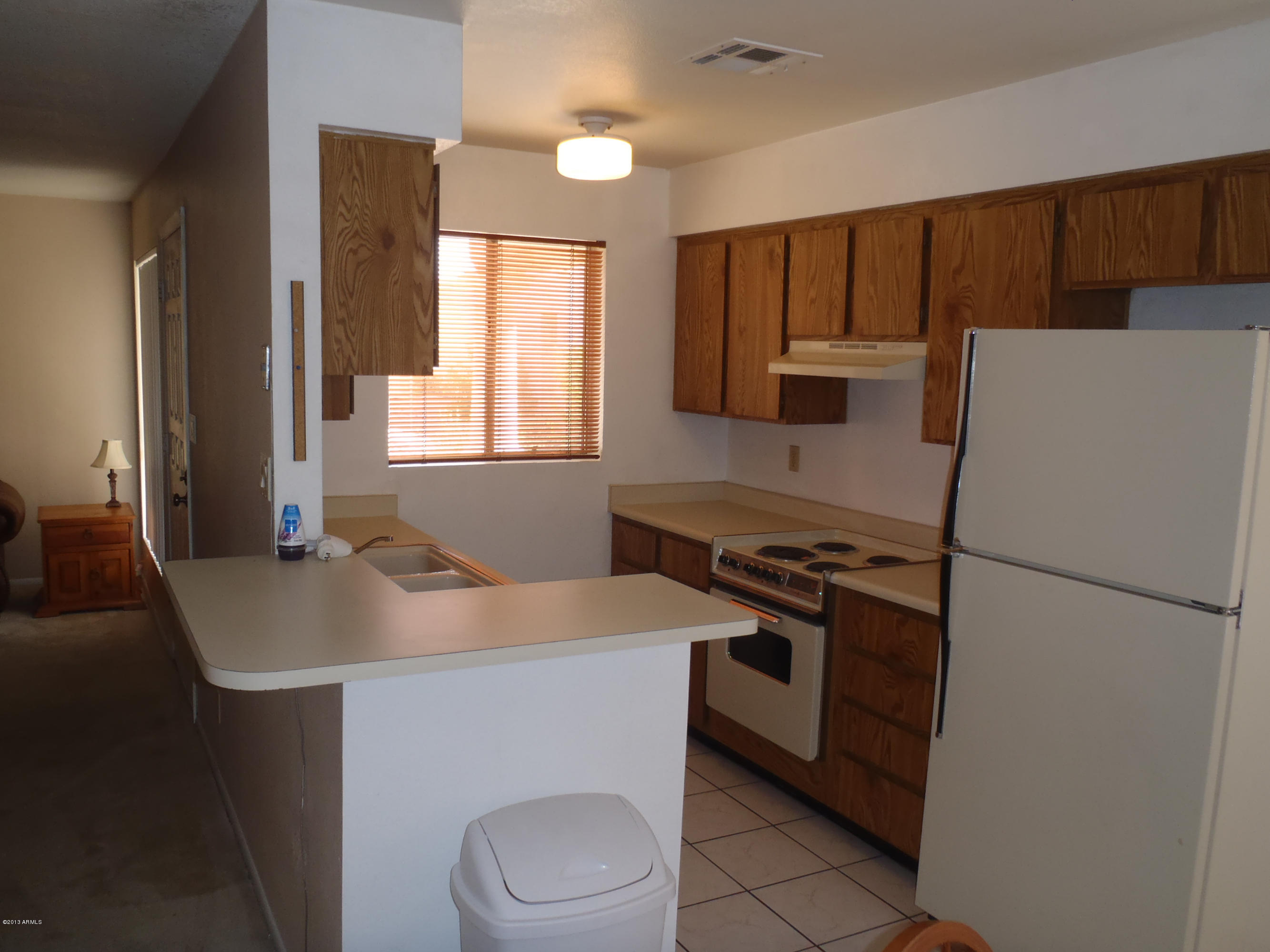 95 North Cooper Road, Unit 45 Chandler, AZ 85225 - Photo 3 of 26 a kitchen with a refrigerator a stove a sink and a microwave