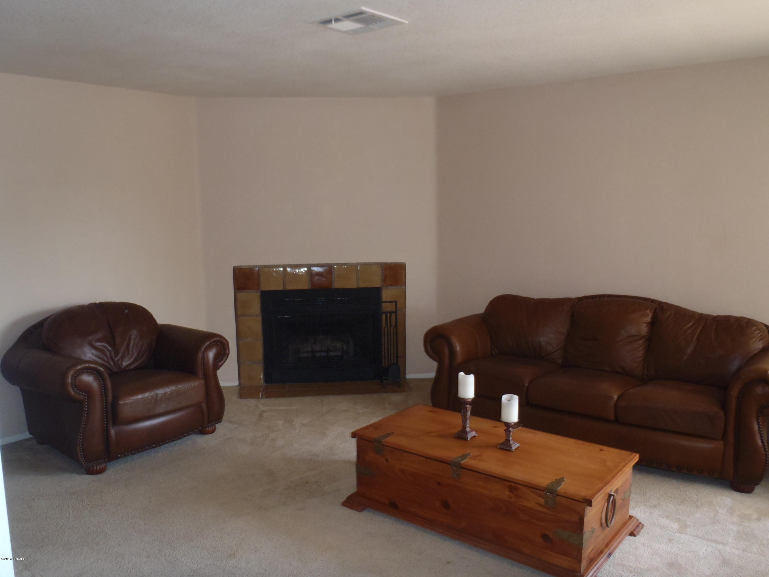 95 North Cooper Road, Unit 45 Chandler, AZ 85225 - Photo 8 of 26 a living room with furniture and a fireplace
