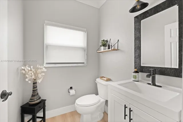 a kitchen with stainless steel appliances kitchen island granite countertop a sink a stove and refrigerator