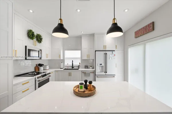 a kitchen with a sink stove and cabinets