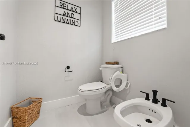 a bedroom with a bed and a television