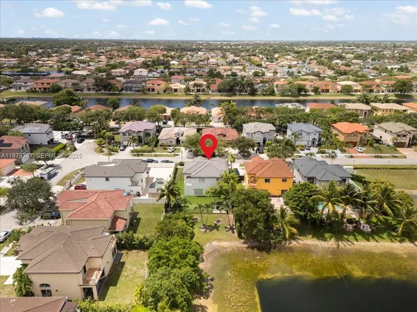 an aerial view of residential houses with outdoor space