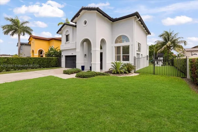 a front view of a house with a garden