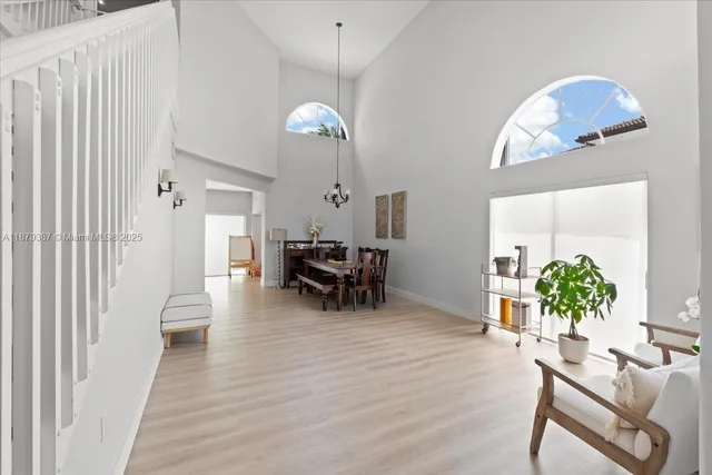 a view of a dining room with furniture and chandelier