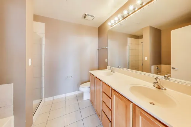 a bathroom with a sink a toilet and mirror