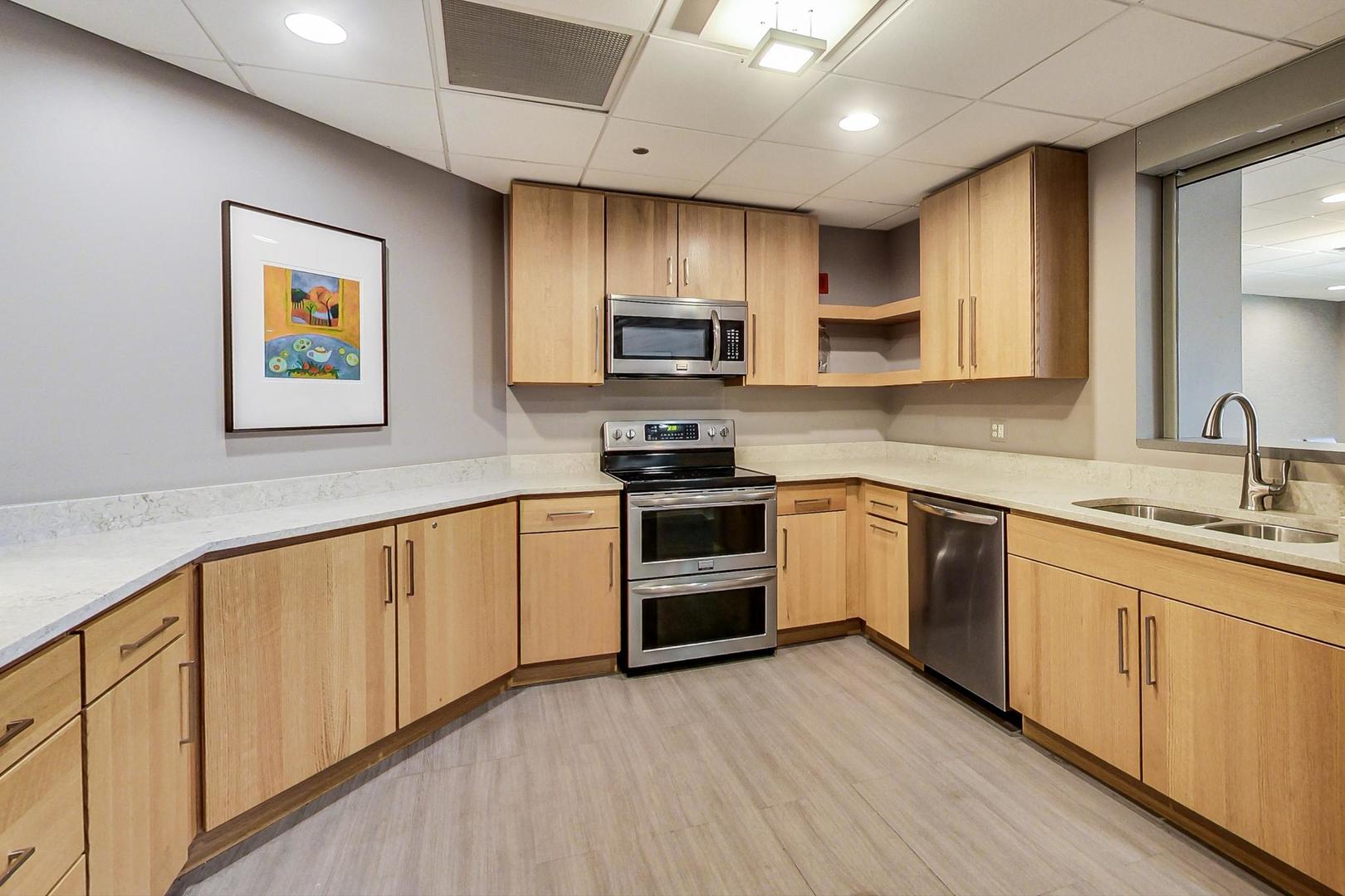 1717 South Prairie Avenue, Unit 1910 Chicago, IL 60616 - Photo 40 of 48 a kitchen with stainless steel appliances granite countertop a stove a sink and a microwave