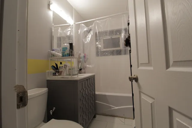 a bathroom with a sink toilet and shower