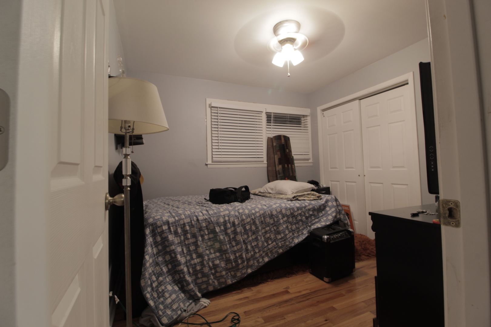 18157 Rockwell Avenue Homewood, IL 60430 - Photo 12 of 21 a bedroom with a bed and a chandelier