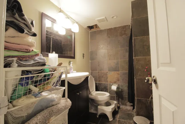 a bathroom with a sink toilet and shower