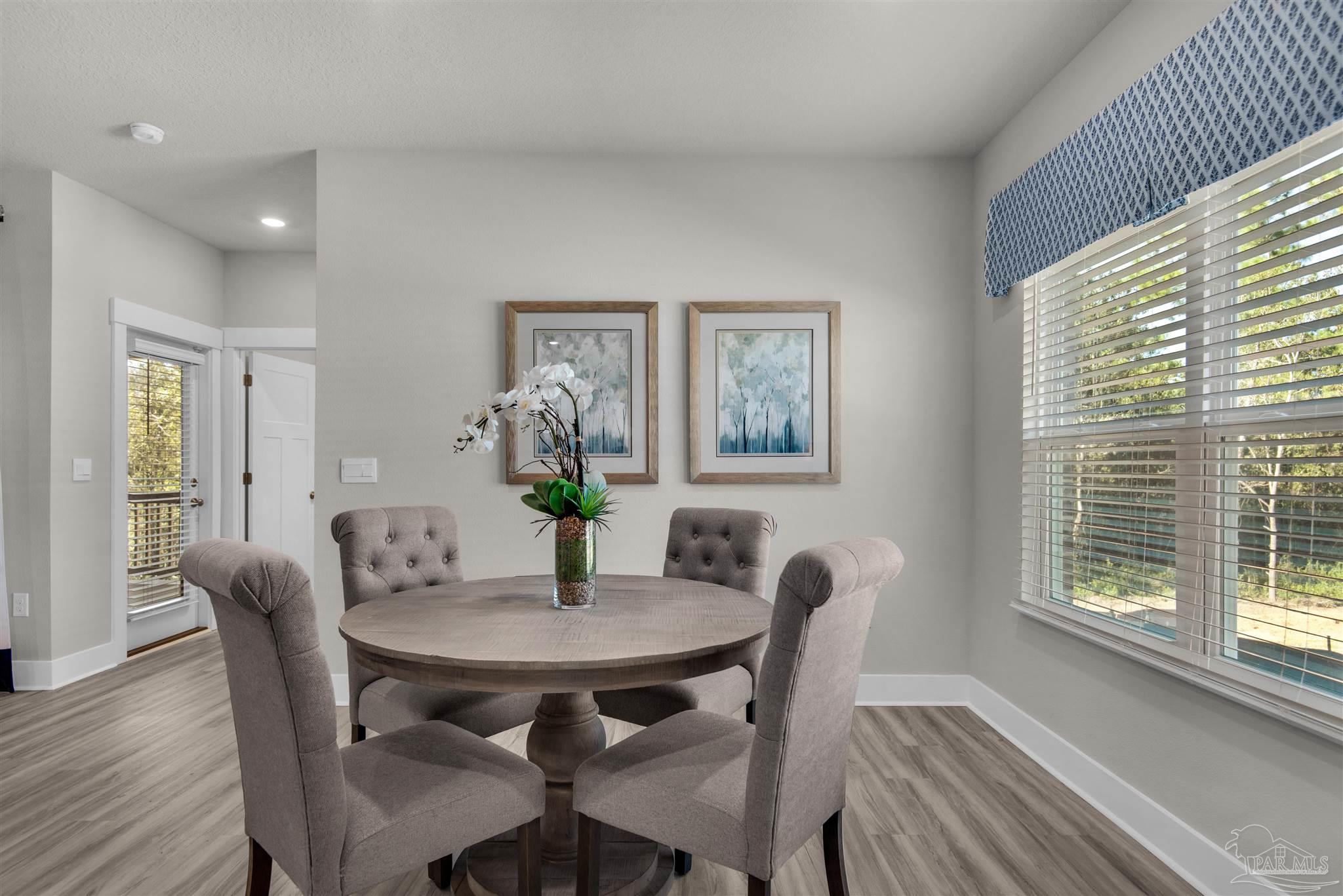 5658 Clarity Street Milton, FL 32570 - Photo 16 of 37 a view of a dining room with furniture and wooden floor