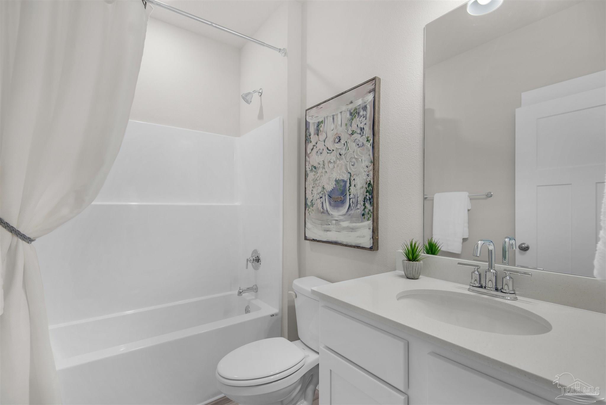 5658 Clarity Street Milton, FL 32570 - Photo 35 of 37 a bathroom with a granite countertop sink a toilet and bathtub