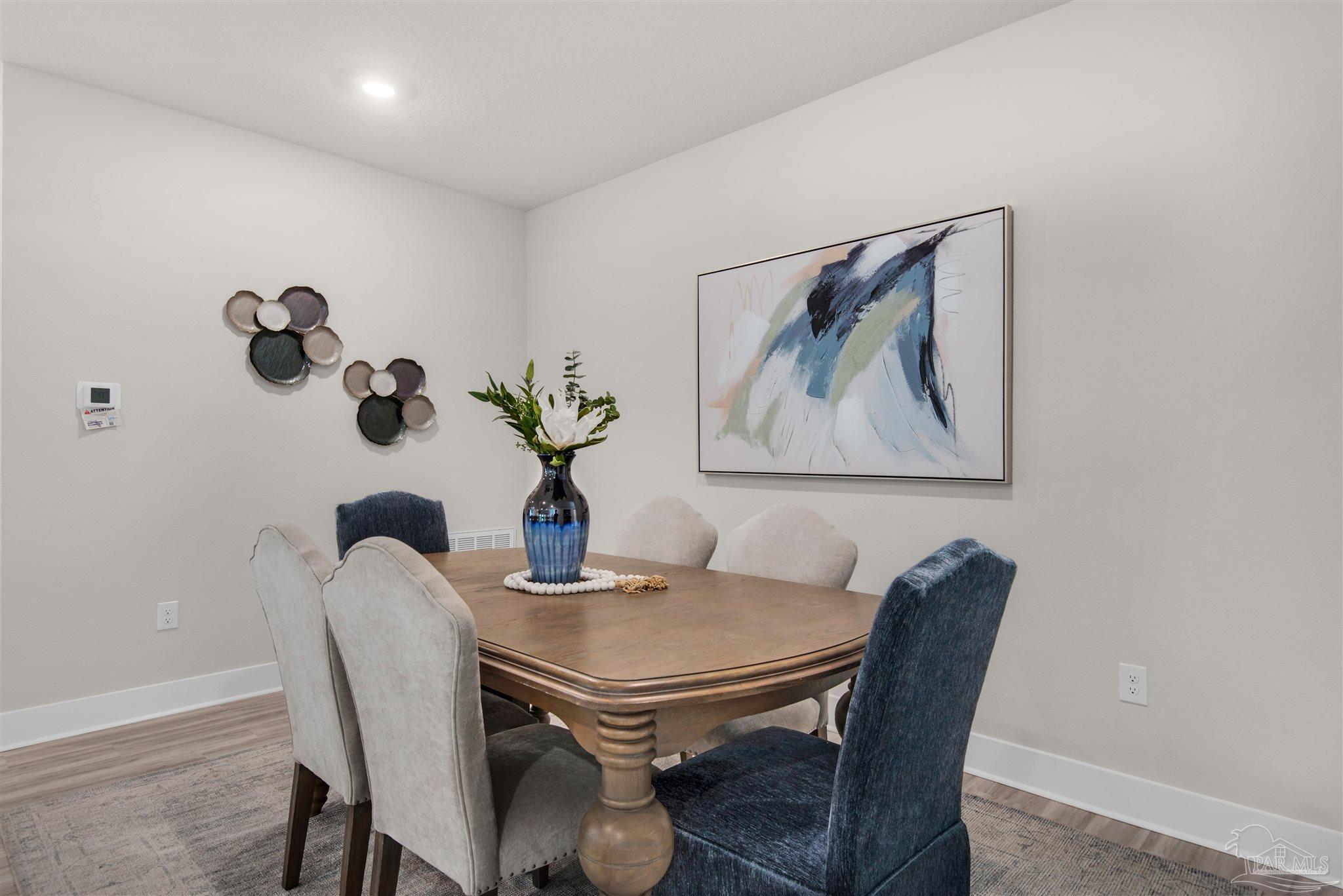 5658 Clarity Street Milton, FL 32570 - Photo 8 of 37 a dining room with furniture and wooden floor