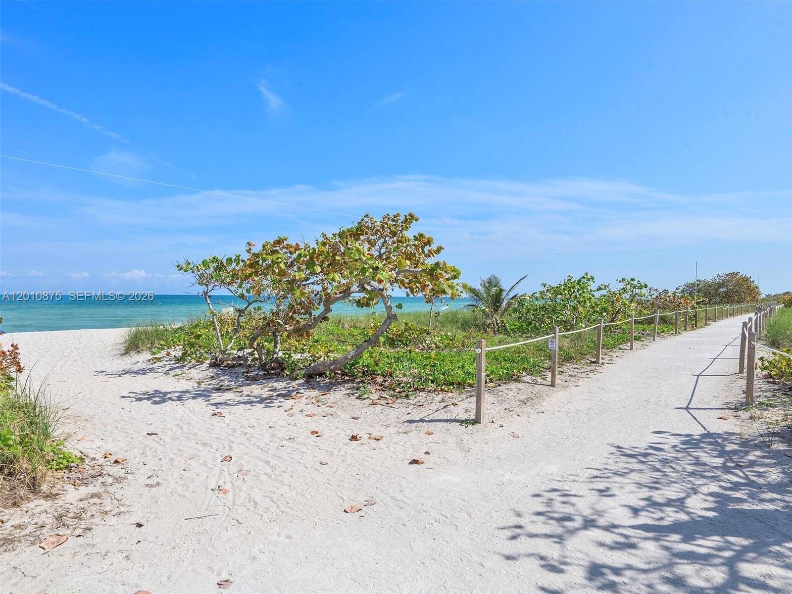 8925 Collins Avenue, Unit 12D Surfside, FL 33154 - Photo 30 of 35 a view of a dry yard with wooden fence