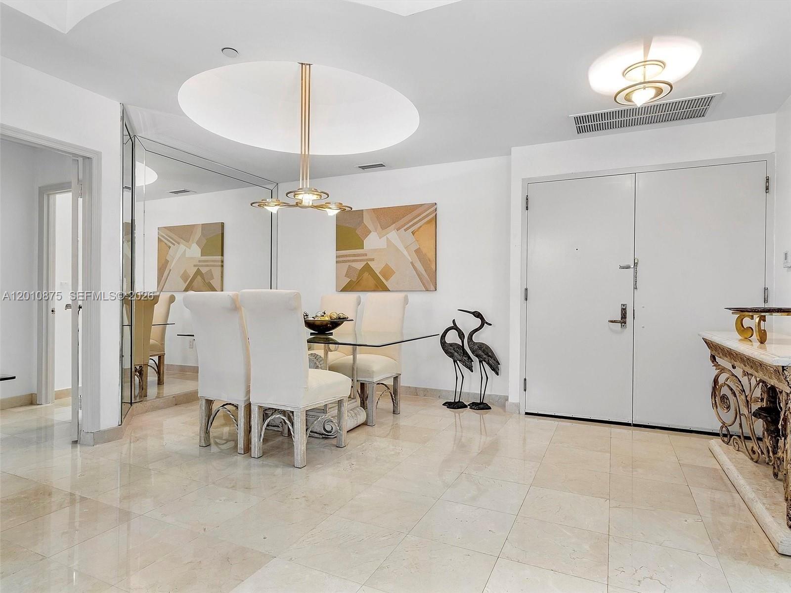 8925 Collins Avenue, Unit 12D Surfside, FL 33154 - Photo 3 of 35 a view of a livingroom with furniture and chandelier
