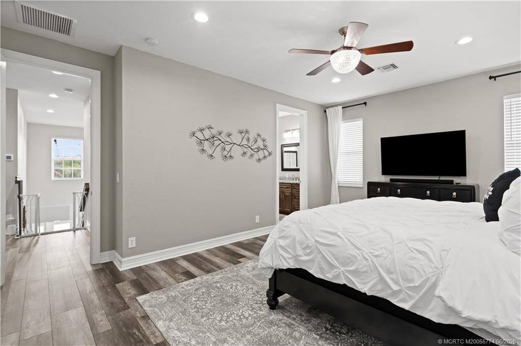1268 Southeast Kirk Street Stuart, FL 34997 - Photo 33 of 63 a bedroom with a bed and a flat screen tv