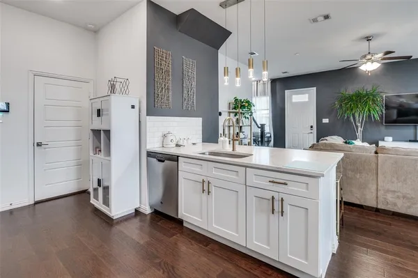 a spacious bathroom with a granite countertop sink a mirror and shower