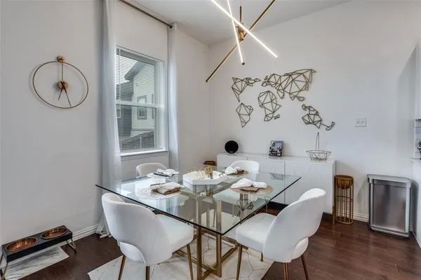 a dining room with furniture a window and wooden floor
