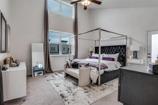 a bed sitting in a bedroom next to a window