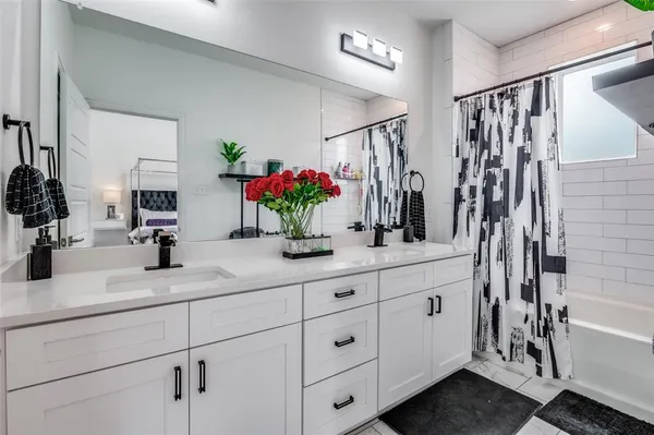 a bedroom with a bed and painting on the wall