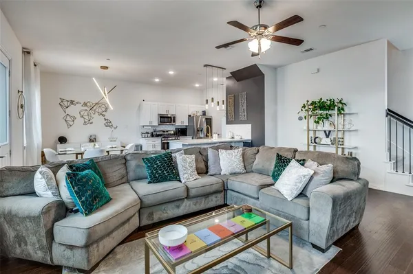 a living room with furniture and a chandelier